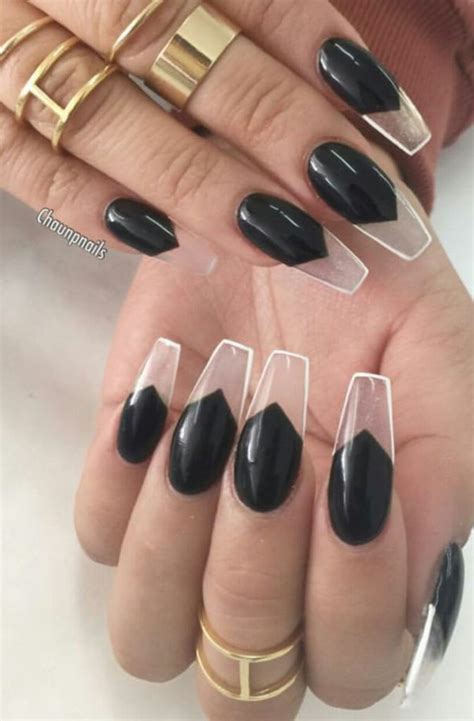 clear nails with black designs.